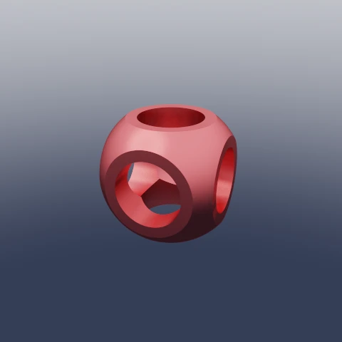 A red pillowed cube with a cylinder bored straight through each of its three axes.